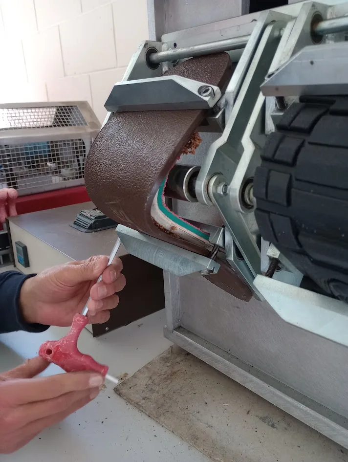 Technician examining safety footwear during flex testing at LASRA