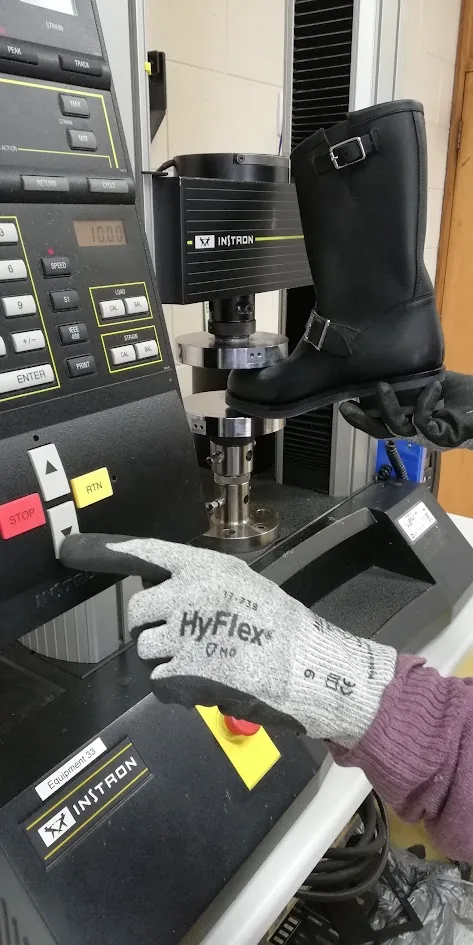 Boot undergoing mechanical compression testing on an Instron machine at LASRA